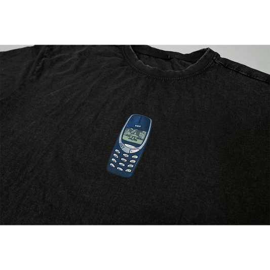 Detailed view of the front T-shirt print featuring a graphic of the Nokia 3310 phone.