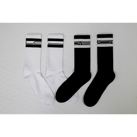 Top-down view of a pair of black socks and a pair of white socks. The white socks have black “Lovejoy” text printed at the top, while the black socks feature white “Lovejoy” text at the top.