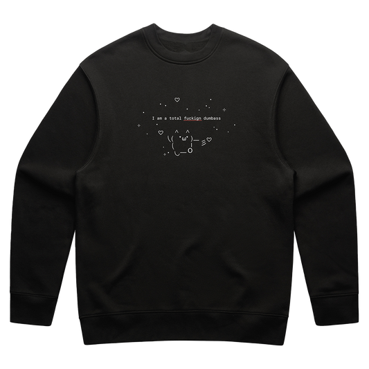 Front view of a black relaxed fit crewneck featuring a small white print across the chest that reads “I’m a total fuckign dumbass,” with a red squiggly underline beneath the misspelled word “fuckign.” Surrounding the text is a small figure and fine-line drawings of stars and hearts.