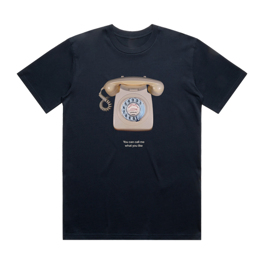Front view of a navy unisex short-sleeve T-shirt featuring a retro telephone photo print across the front, with the text “You can call me what you like” printed underneath.